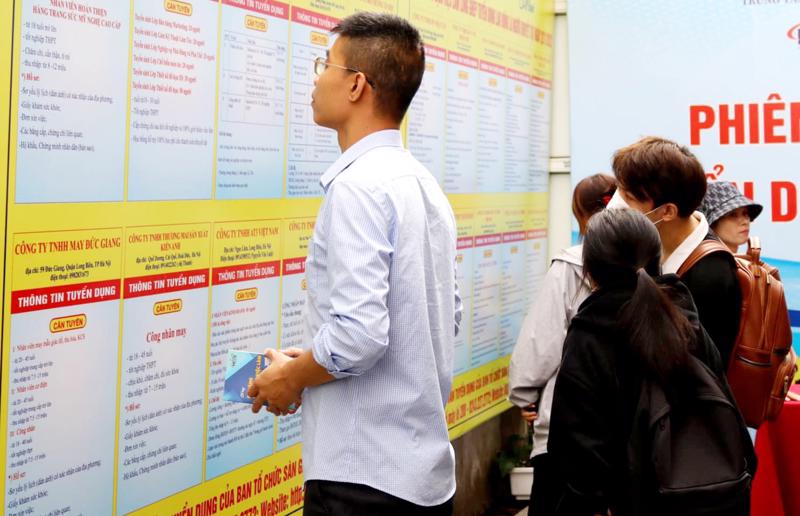 Lao động thất nghiệp tìm hiểu thông tin việc làm. Ảnh: Nhật Dương.