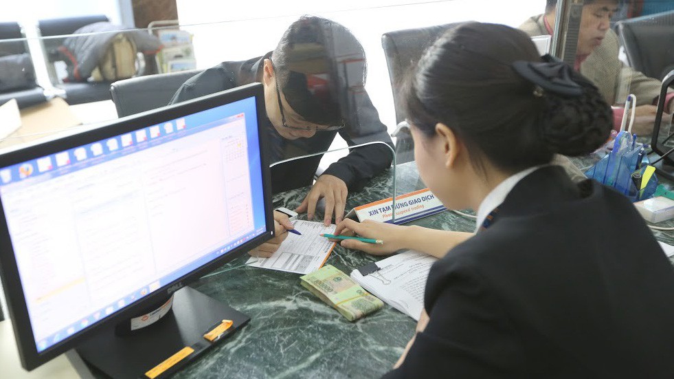 Theo báo cáo của Ngân hàng Nhà nước, đến cuối 2017 tín dụng đối với lĩnh vực đầu tư kinh doanh chứng khoán chiếm tỷ trọng không đáng kể - Ảnh: Quang Phúc.
