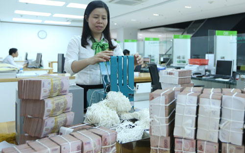 Ngân hàng Nhà nước cho biết, thực tế thanh khoản của cả hệ thống ngân hàng hiện vẫn đang trong trạng thái khá dồi dào - Ảnh: Quang Phúc.<br>