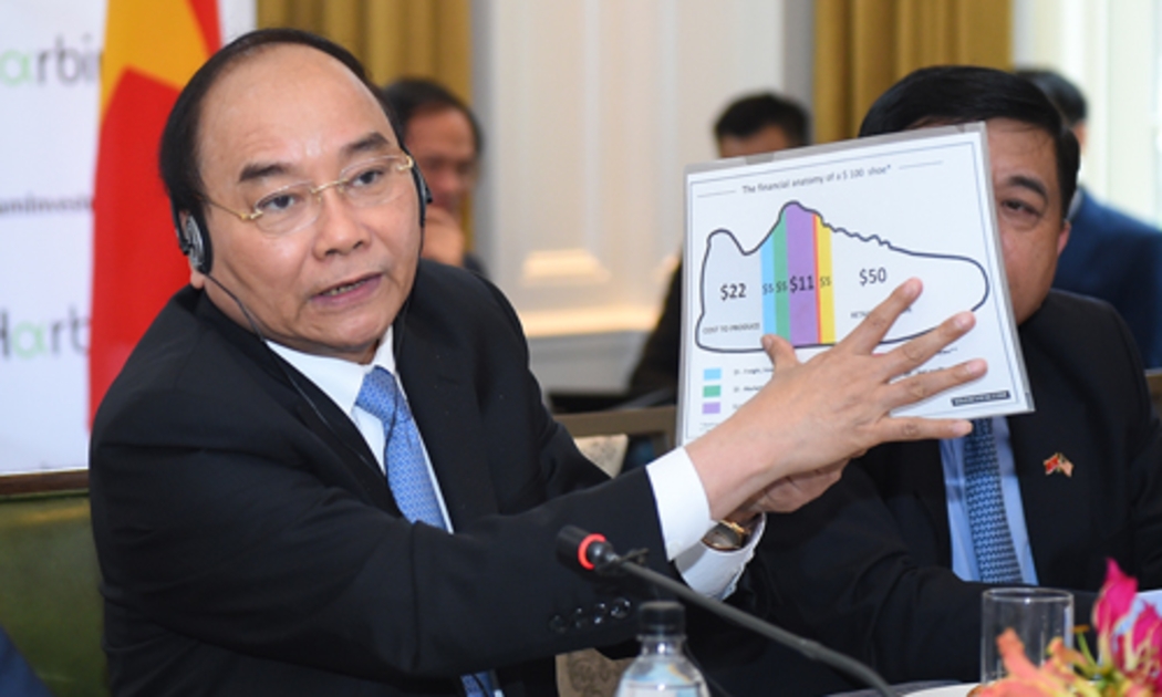 Thủ tướng dùng hình ảnh đôi giày để minh họa lợi nhuận của các nhà đầu tư Hoa Kỳ tại Việt Nam - Ảnh: VGP.