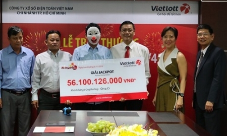 Một người trúng giải xổ số của Vietlott đeo mặt nạ nhận thưởng.