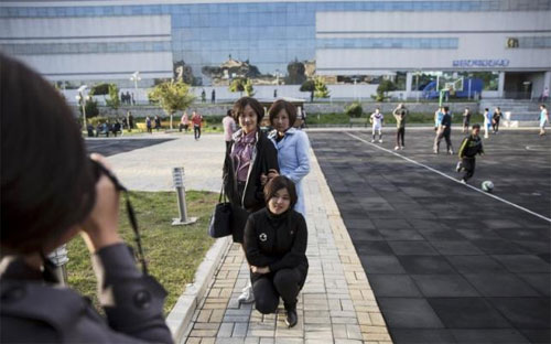 Các cô gái trẻ đang chụp ảnh trước bách hóa Pothonggang ở Bình Nhưỡng - Ảnh: Reuters.<br>