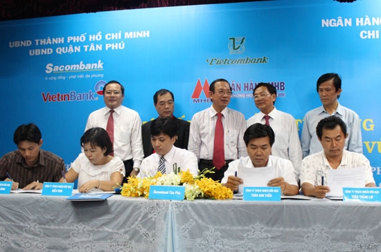 Ông Trầm Bê (đứng phía sau thứ hai từ trái qua phải) chứng kiến lễ ký tài trợ vốn cho doanh nghiệp sáng nay - Ảnh: Sacombank.