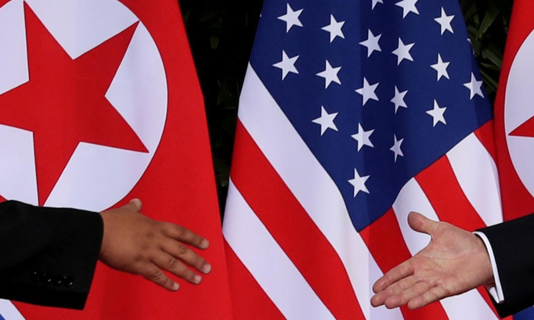 Nhà lãnh đạo Triều Tiên Kim Jong Un và Tổng thống Mỹ Donald Trump đưa tay ra bắt tại cuộc gặp ở Singapore tháng 6/2018 - Ảnh: Reuters.
