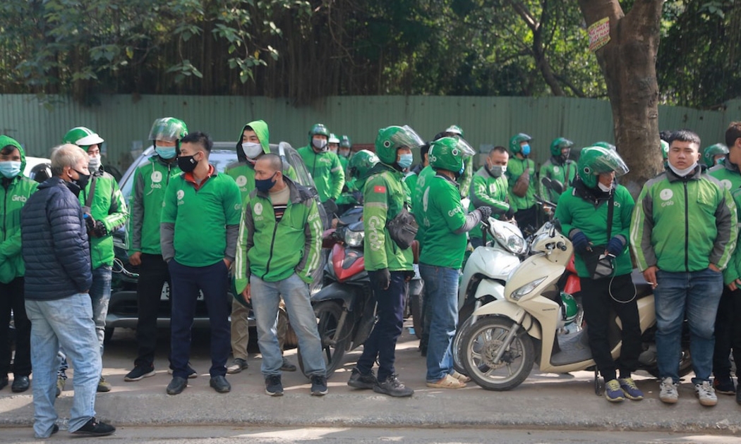 Hàng trăm tài xế Grab tập trung trước trụ sở của Grab tại ngõ 78 phố Duy Tân sáng 7/12 để phản đối mức khấu trừ mới mà hãng này áp dụng.