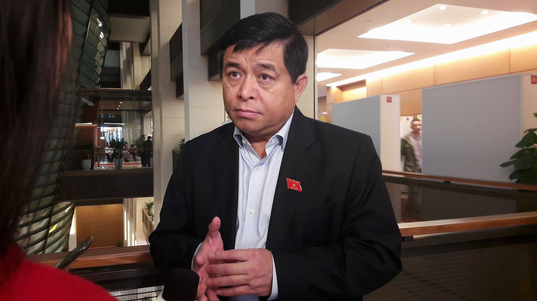 Bộ trưởng Bộ Kế hoạch và đầu tư Nguyễn Chí Dũng trao đổi với báo chí bên hành lang Quốc hội.