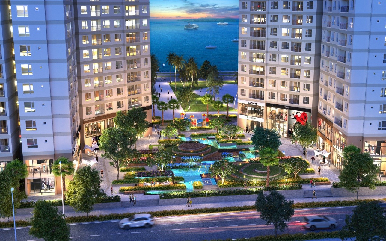 Khuôn viên xanh bên dưới tòa nhà với hồ cảnh và đài phun nước.