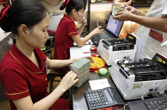 Theo Công ty Chứng khoán Tp.HCM - HSC, nếu lãi suất cho vay bị ép giảm quá nhanh thì sẽ có rủi ro làm đảo ngược dòng vốn đầu cơ hưởng chênh lệch giữa lãi suất tiền đồng và USD; khiến dòng vốn này chảy ra khỏi tiền đồng, gây áp lực lên tỷ giá - Ảnh: Reuters.