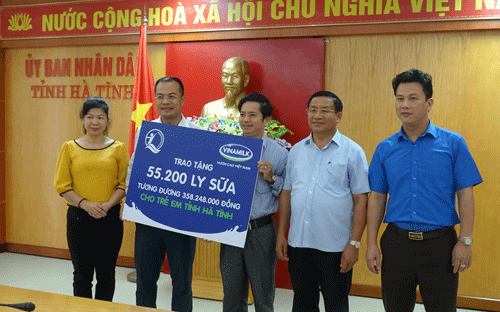 Bà Lê Tuyết Mai, Phó giám đốc Quỹ Bảo trợ trẻ em Việt Nam và ông Đậu Phi
 Tú, Giám đốc trang trại Vinamilk Hà Tĩnh trao bảng tượng trưng 55.200 
ly sữa, tương đương 358.248.000 đồng cho trẻ em vùng lũ Hà Tĩnh.
