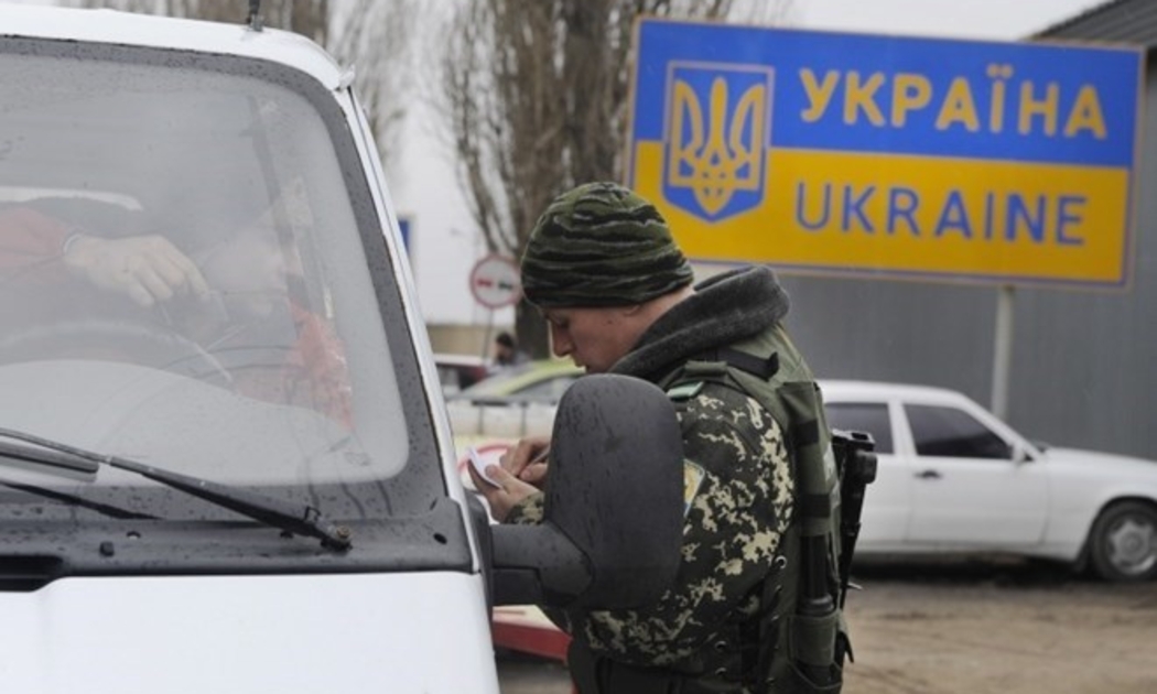 Lực lượng Biên phòng Ukraine kiểm tra giấy tờ người dân qua lại biên giới với Nga - Ảnh: Itar-Tass.<br>