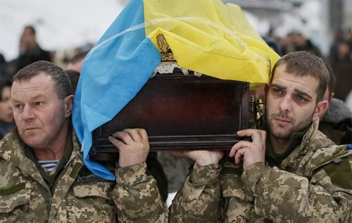 Hai binh sỹ quân đội Ukraine trong đám tang một đồng đội thiệt mạng ở miền Đông nước này hôm 20/1 - Ảnh: BBC/Reuters.<br>