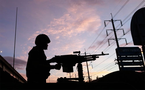 Một binh sỹ Thái Lan đứng gác ở Bangkok sáng sớm ngày 20/5 - Ảnh: AP.<br>