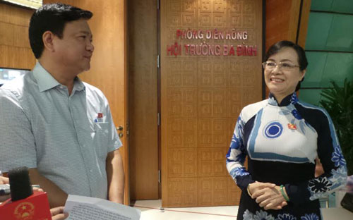 Đại biểu Nguyễn Thị Quyết Tâm và Bộ trưởng Đinh La Thăng bên hành lang Quốc hội sáng 18/6.<br>