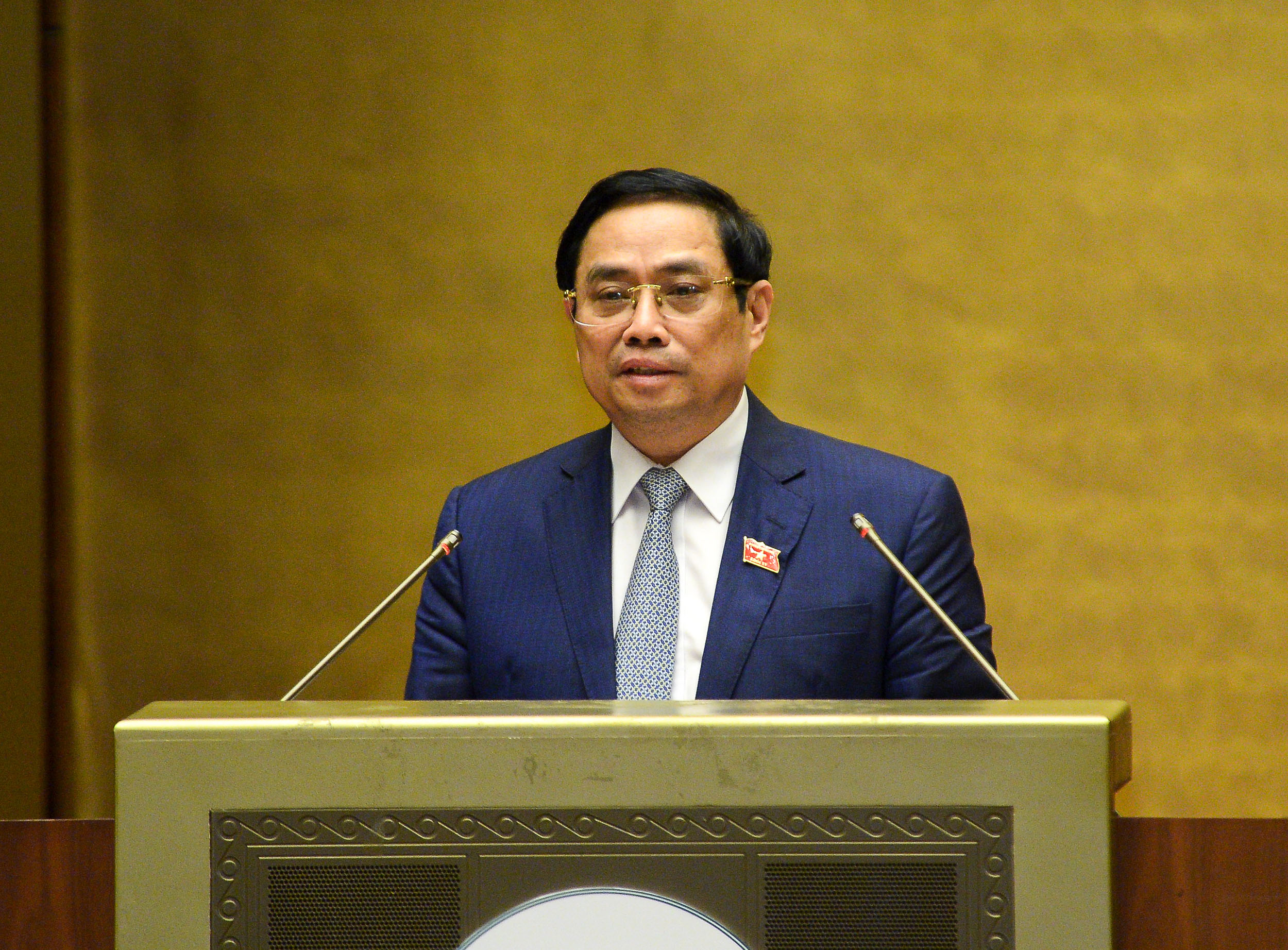 Thủ tướng Chính phủ nhiệm kỳ 2016-2021 Phạm Minh Chính trình bày Tờ trình về cơ cấu tổ chức của Chính phủ nhiệm kỳ Quốc hội khóa XV - Ảnh: Quochoi.vn