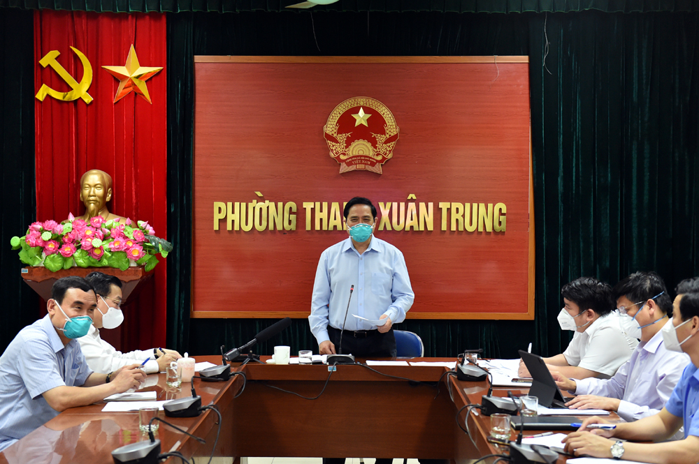 Chiều muộn cùng ngày, tại trụ sở UBND phường Thanh Xuân Trung, Thủ tướng chủ trì cuộc làm việc trực tuyến với Sở Chỉ huy phòng chống Covid-19 của Thành phố, kết nối với điểm cầu UBND Thành phố, các quận huyện và toàn bộ 579 xã, phường, thị trấn của Hà Nội. Thủ tướng Chính phủ ghi nhận, biểu dương những thành tựu, kết quả của Hà Nội trong thực hiện mục tiêu kép vừa phòng chống dịch hiệu quả, vừa phát triển kinh tế - xã hội, trong bối cảnh Thủ đô có rất nhiều đặc thù, khác biệt so với các địa phương khác. Tuy nhiên, Thủ tướng nêu rõ, qua kiểm tra thực tế, vẫn còn một số bất cập. Do đó, Thủ tướng yêu cầu Thành phố tăng cường kiểm tra, giám sát, kịp thời phát hiện, uốn nắn, điều chỉnh các bất cập, hạn chế, đồng thời  giúp đỡ xã, phường, thị trấn về nguồn lực con người và vật chất. Ảnh: VGP.