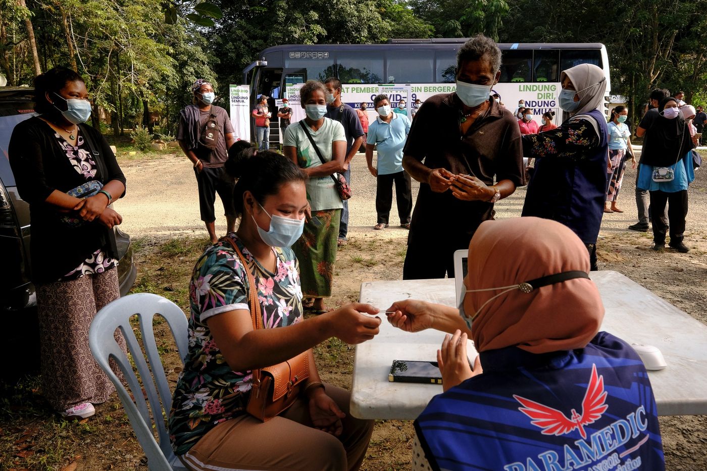 Người dân đi tiêm vaccine Covid tại một điểm tiêm chủng lưu động ở Selangor, Malaysia, đầu tháng 7/2021 - Ảnh: Bloomberg.