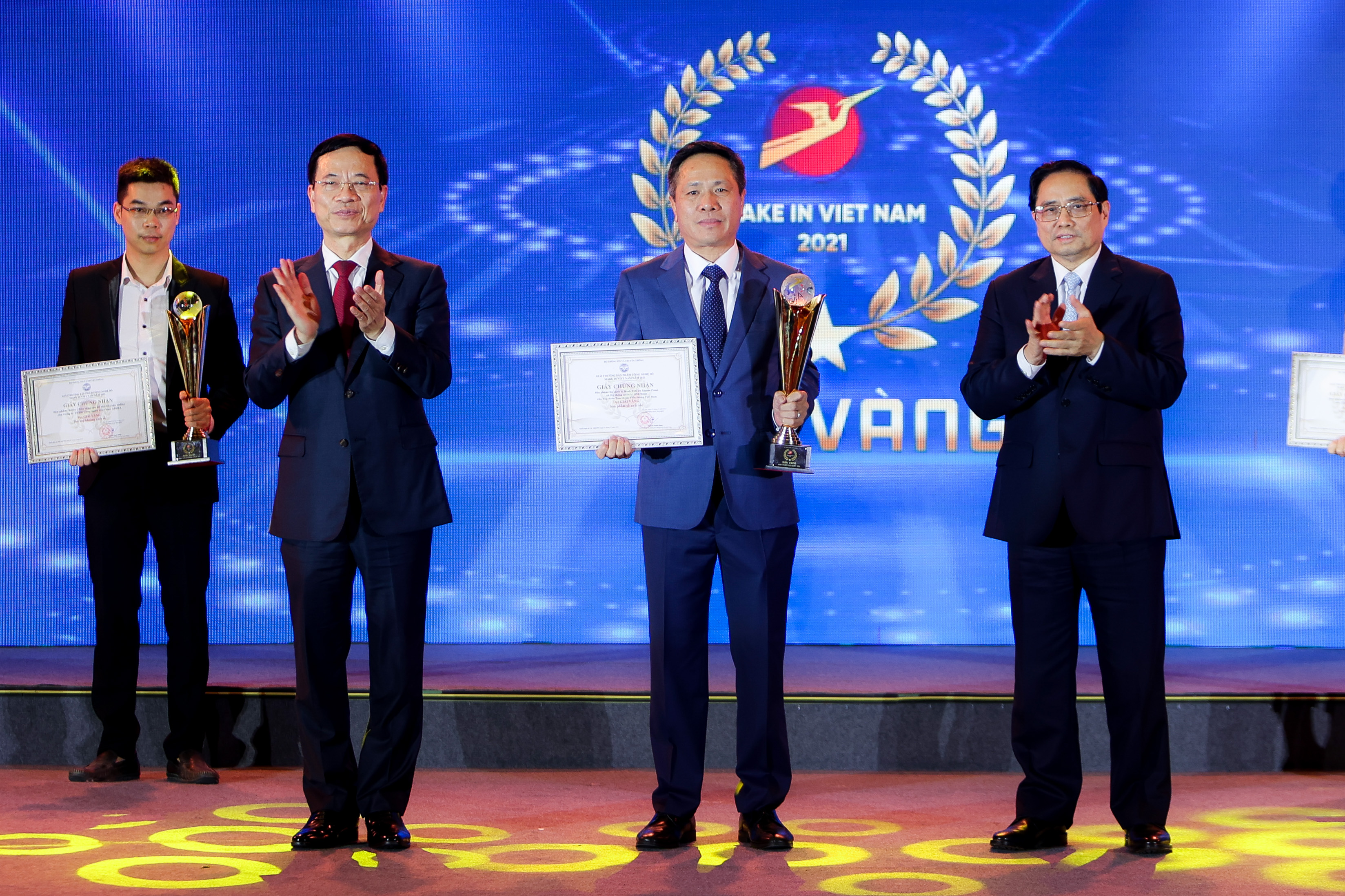 Chủ tịch Hội đồng thành viên VNPT Tô Dũng Thái nhận giải Vàng Make in Viet Nam 2021 cho các sản phẩm công nghệ số của VNPT do Thủ tướng Phạm Minh Chính và Bộ trưởng Bộ Thông tin và Truyền thông Nguyễn Mạnh Hùng trao. Ảnh: Nguyễn Khánh.