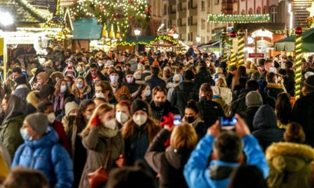 Người dân đeo khẩu trang tại khu chợ Giáng sinh ở Frankfurt, Đức, vào ngày 11/12/2021 - Ảnh: AP