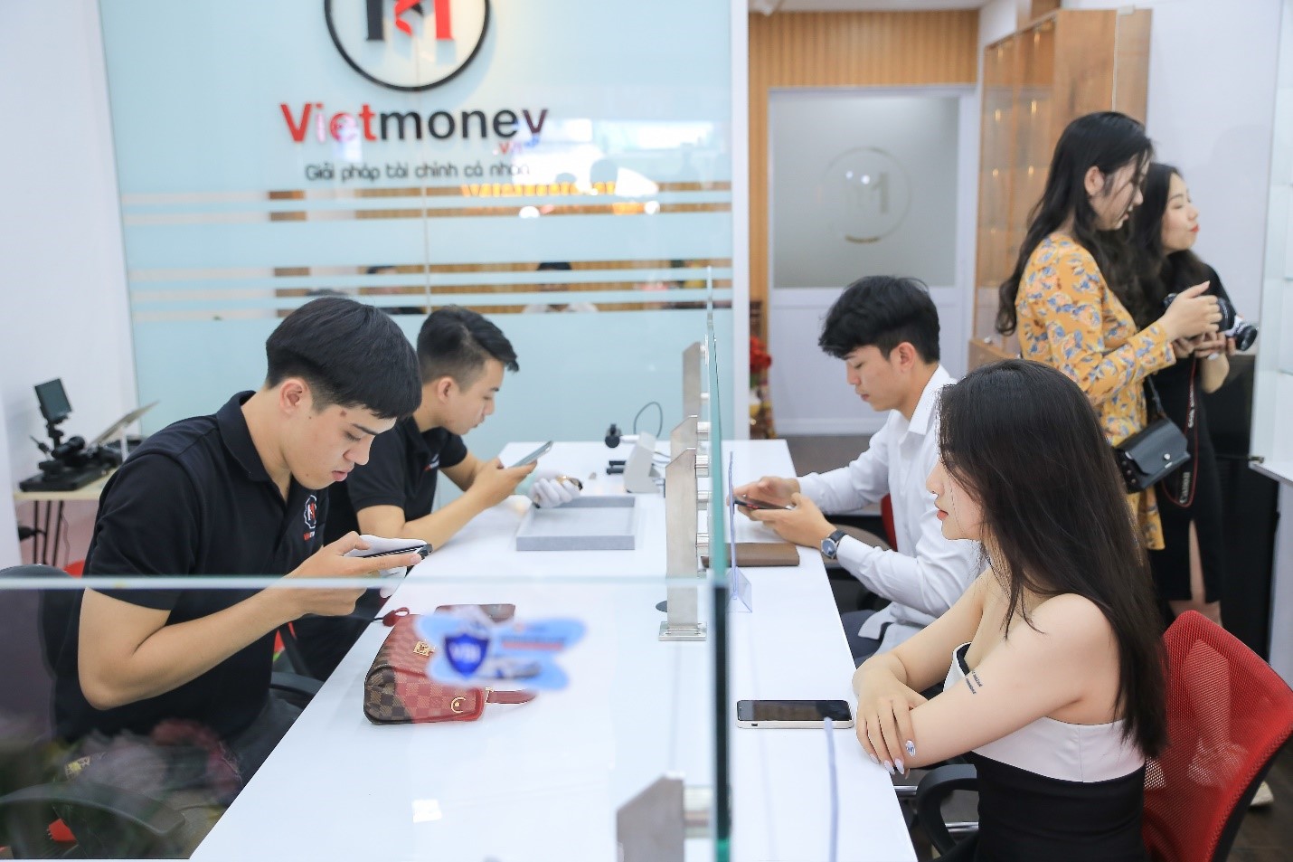 Customers making pawn transactions at a VietMoney store.