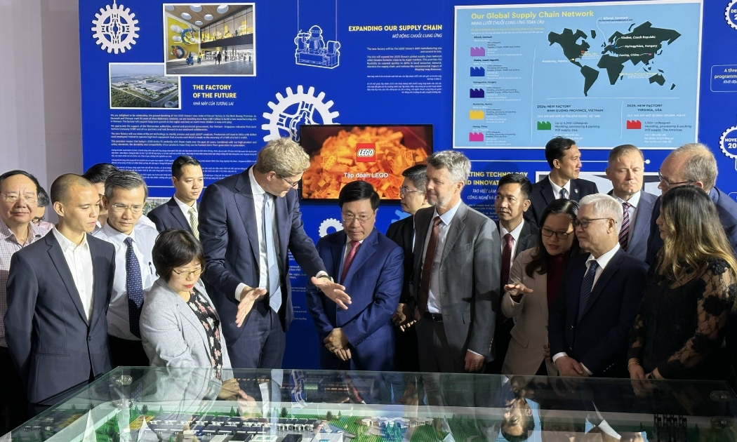 Ông Niels B. Christiansen, Tổng giám đốc điều hành Tập đoàn LEGO, đang giới thiệu mô hình, quy mô nhà máy LEGO thứ sáu cho Phó Thủ tướng Phạm Bình Minh, Thái tử kế vị Hoàng gia Đan Mạch Frederik...