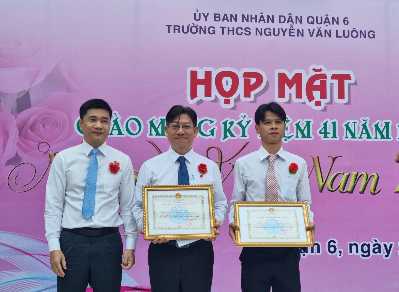 Phó Giám đốc Bảo hiểm xã hội TP.HCM Trần Dũng Hà trao tặng Giấy khen tới tập thể Trường THCS Nguyễn Văn Luông, thầy giáo Đinh Phú Cường - Hiệu trưởng nhà trường. Ảnh - BHXH Việt Nam.