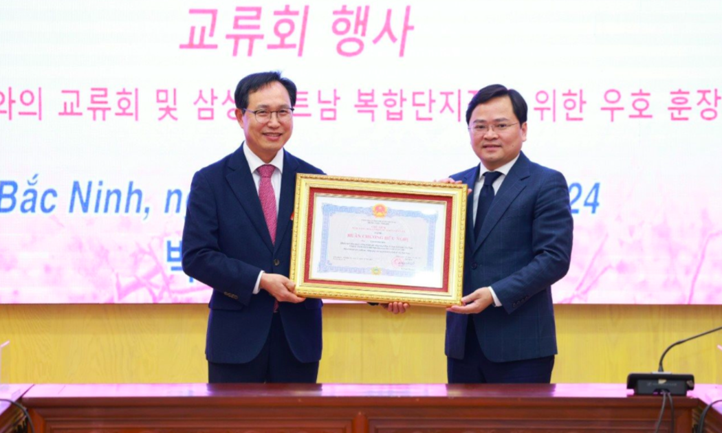 Ông Nguyễn Anh Tuấn, Bí thư tỉnh ủy Bắc Ninh trao tặng Huân chương Hữu Nghị cho ông Choi Joo Ho, Tổng Giám đốc Tổ hợp Samsung Việt Nam.