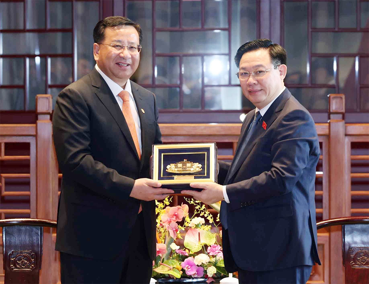 Chủ tịch Quốc hội Vương Đình Huệ trao tặng quà lưu niệm cho Chủ tịch Hội đồng quản trị Tập đoàn Xây dựng công trình đường sắt Trung Quốc (CRCC) Đới Hòa Căn. Ảnh: TTXVN.