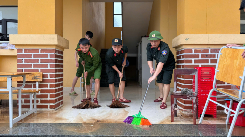 Cán bộ, chiến sĩ Công an tỉnh Quảng Bình đến hỗ trợ các trường học dọn dẹp vệ sinh sau mưa lũ.