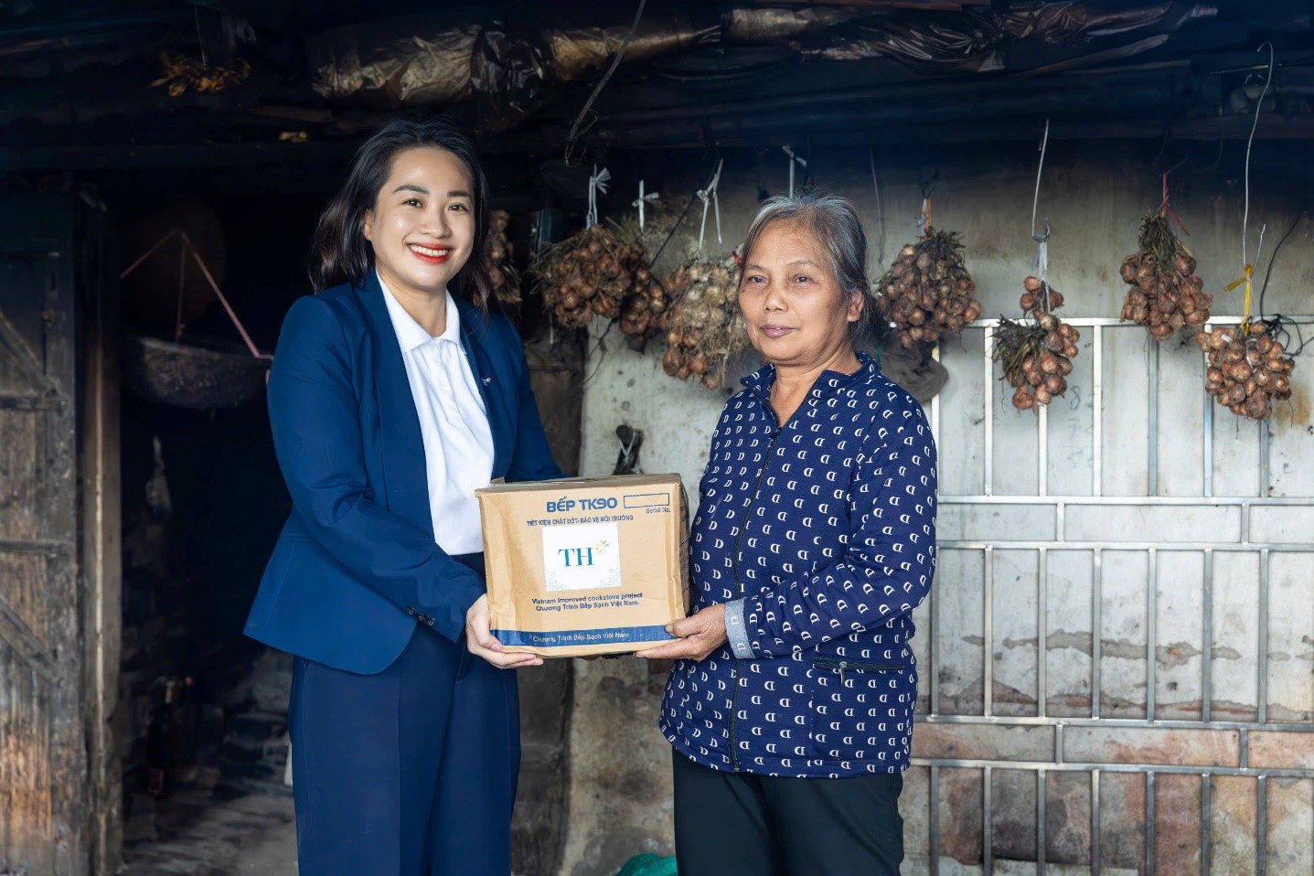 Bà Hoàng Thị Thanh Thủy, Giám đốc Phát triển Bền vững Tập đoàn TH trao tặng bếp đun tiết kiệm năng lượng tại Nam Định tháng 3/2025. Ảnh: Minh Sơn.