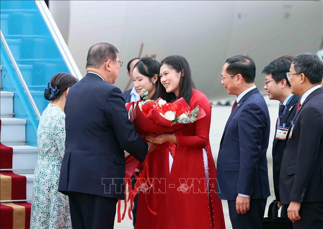 Thiếu nữ Hà Nội tặng hoa, chào mừng Thủ tướng Nhật Bản Ishiba Shigeru và Phu nhân thăm chính thức Việt Nam - Ảnh: TTXVN