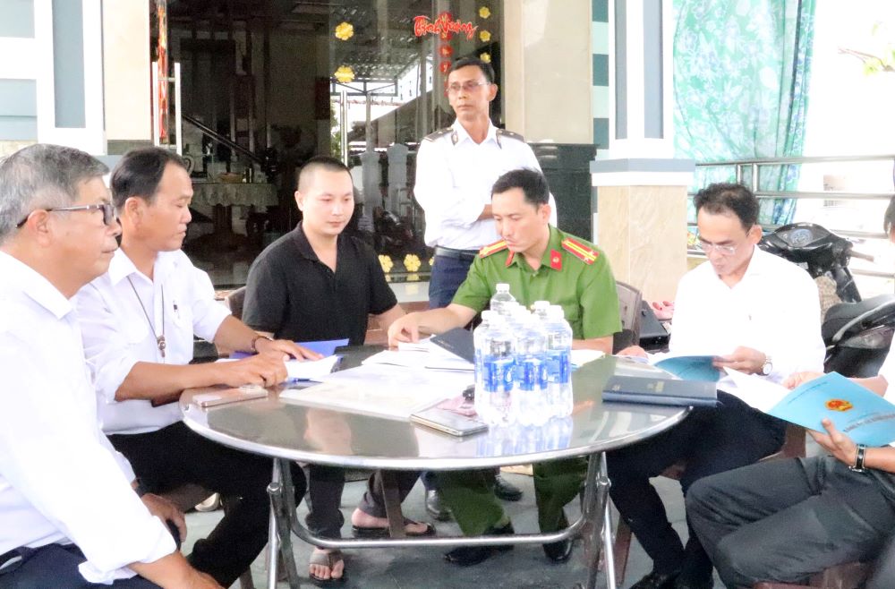 &Ocirc;ng Nguyễn Ch&iacute; Cường (người mặc &aacute;o m&agrave;u đen) cung cấp c&aacute;c giấy tờ cho đo&agrave;n kiểm tra.