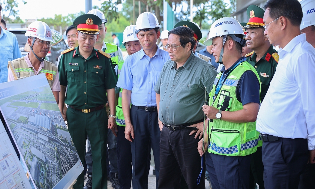 Thủ tướng nghe báo cáo dự án xây dựng Nhà ga T2 hành khách và mở rộng sân đỗ máy bay cảng hàng không Đồng Hới. Ảnh: VGP