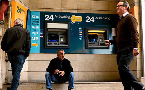 Cảnh người dân Cyprus vật vã trước các máy ATM chờ rút được tiền ra khỏi ngân hàng đã xuất hiện nhiều ngày nay trên các báo lớn ở châu Âu - Ảnh: Getty.<br>