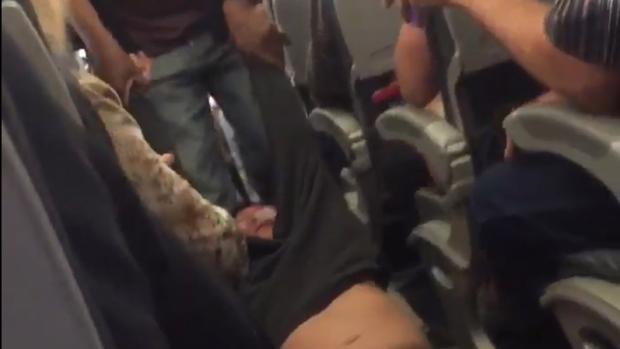 Hành khách bị lôi khỏi máy bay United Airlines hôm 9/4 - Ảnh cắt từ clip.<br>