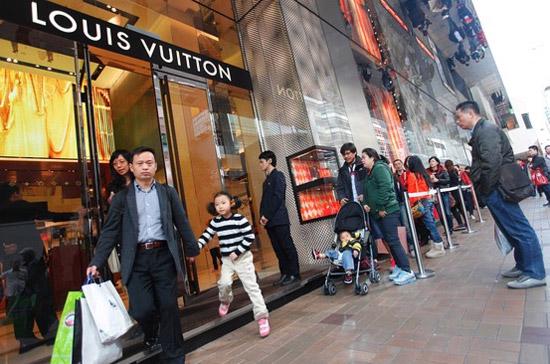 Người tiêu dùng xếp hàng bên ngoài một cửa hiệu Louis Vuitton ở Hồng Kông hồi đầu năm nay - Ảnh: AFP.