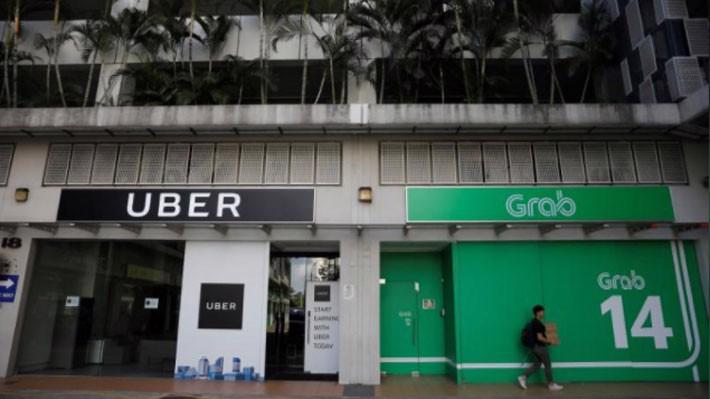 Văn phòng của Uber và Grab ở Singapore hồi tháng 3/2017 - Ảnh: Reuters.