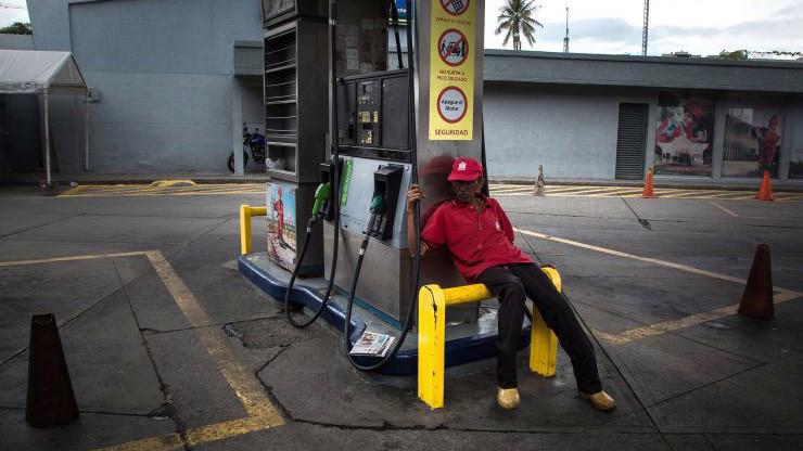 Một nhân viên trông coi một trạm xăng ở Caracas, Venezuela hồi tháng 9/2017 - Ảnh: Bloomberg/CNBC.