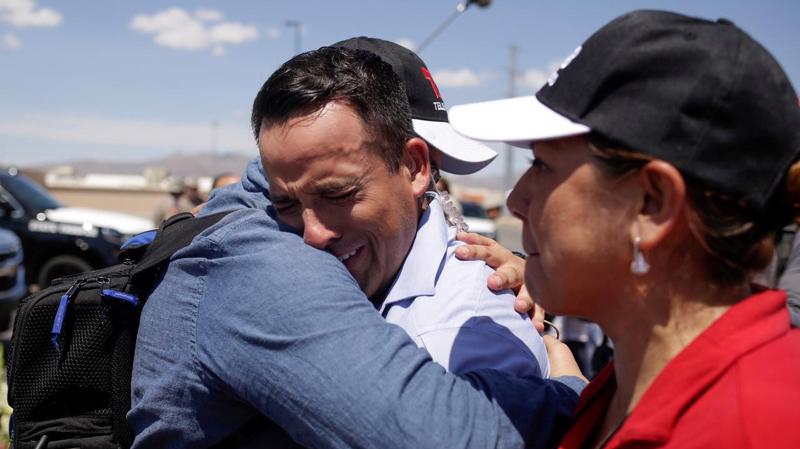 Một phóng viên truyền hình chia sẻ nỗi đau với người dân ở El Paso sau vụ xả súng ngày thứ Bảy - Ảnh: Reuters.