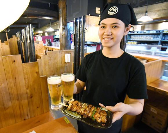 Một sinh viên người Việt Nam phục vụ trong một nhà hàng gà rán Torikizoku ở Osaka, Nhật Bản - Ảnh: Nikkei.
