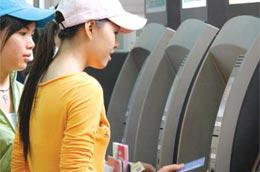 Khách hàng giao dịch qua máy ATM của Vietcombank - Ảnh: Lê Toàn.