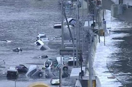 Ôtô bị cuốn trôi tại khu vực đông bắc Nhật Bản sau động đất và sóng thần. 