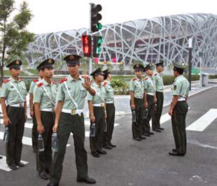 Cảnh sát Trung Quốc phía trước Sân vận động quốc gia Bắc Kinh - còn gọi là Sân Tổ chim - nơi sẽ diễn ra lễ khai mạc Olympic.