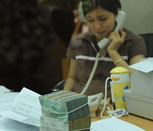 Tiêu chuẩn của giấy tờ có giá của các ngân hàng được cầm cố để vay vốn tại Ngân hàng Nhà nước không nhất thiết phải được phát hành bằng đồng Việt Nam - Ảnh: Quang Liên.
