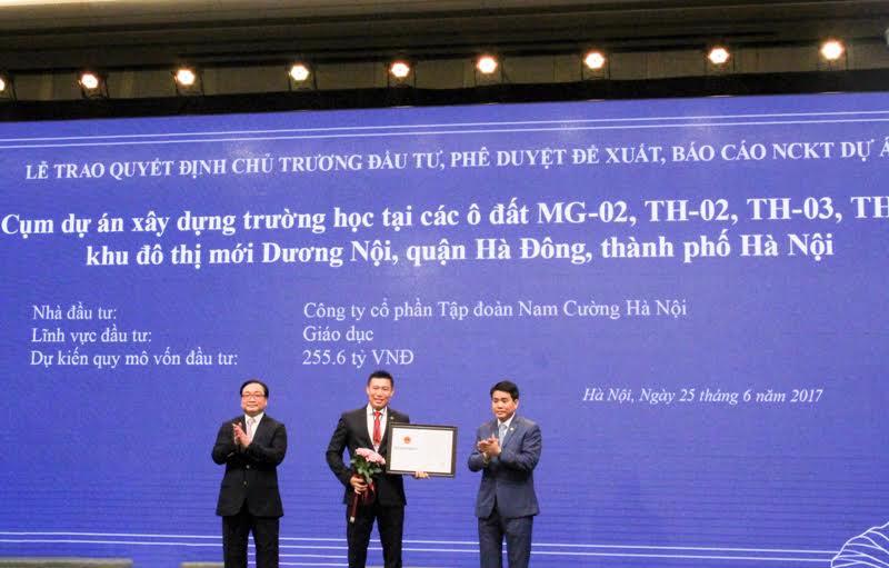 Ông Nguyễn Đức Chung, Chủ tịch UBND Tp.Hà Nội trao quyết định chủ trương đầu tư cụm dự án xây dựng trường học cho ông Trần Văn Nghĩa - Tổng giám đốc Tập đoàn Nam Cường.