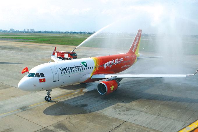 Thủ tục phun vòi rồng cho máy bay mới của Vietjet Air tại sân bay Tân Sơn Nhất - Ảnh: Tuổi Trẻ.<br>