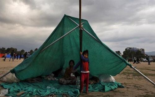 Sau động đất, người dân ở Kathmandu phải dựng lều, trải đệm để qua đêm ngay trên đường phố trong thời tiết có mưa - Ảnh: Reuters.<br>