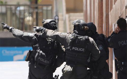 Cảnh sát bên ngoài quán cà phê Lindt ở Sydney, Australia, nơi xảy ra vụ bắt cóc sáng nay (15/12) - Ảnh: AP/Huffington Post.<br>