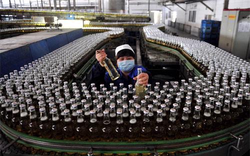 Công nhân làm việc trong một nhà máy bia ở Thẩm Dương, Trung Quốc - Ảnh: Reuters/WSJ.<br>