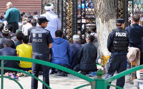 Cảnh sát Trung Quốc đứng bên ngoài một đền thờ hồi giáo của người Duy Ngô Nhĩ - Ảnh: Getty Images.<br>