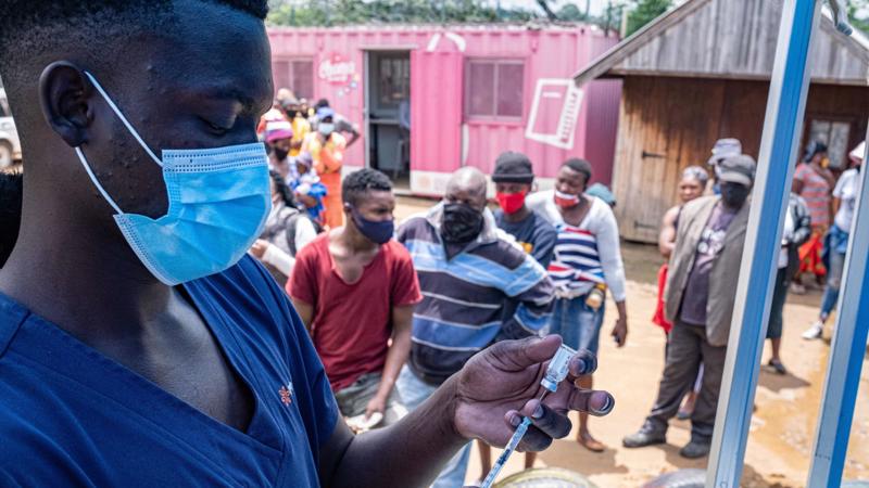Một nhân viên y tế chuẩn bị tiêm vaccine cho người dân tại một khu dân cư ở Johannesburg ngày 8/12/2021 - Ảnh: AFP | Getty Images
